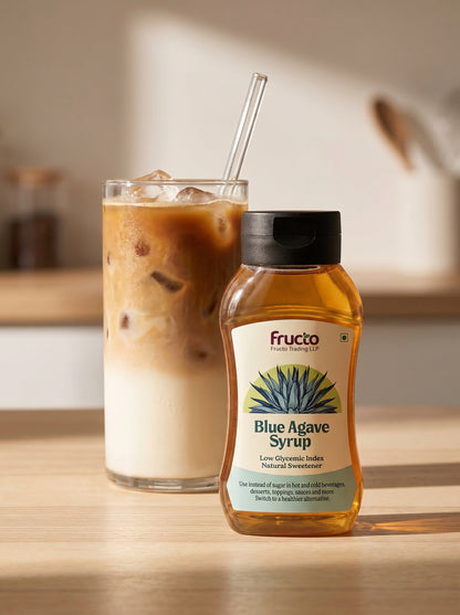 Fructo Blue Agave Syrup bottle with iced coffee on kitchen counter